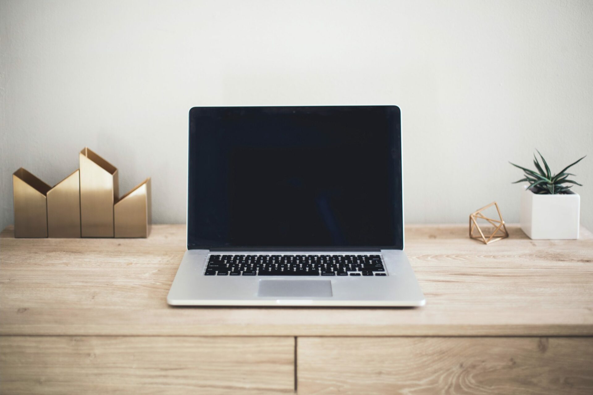 open laptop on wooden desk