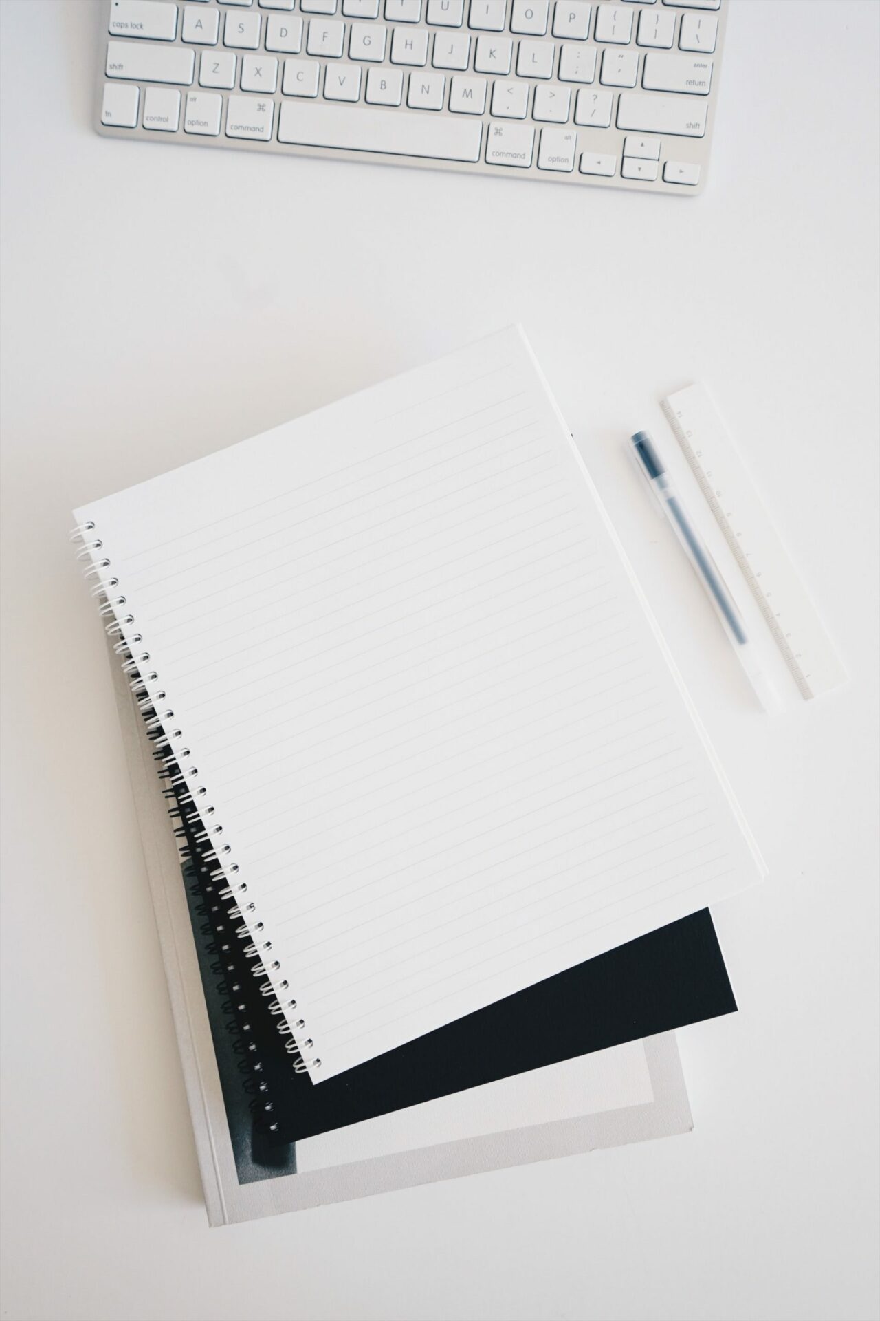 Flat lay with laptop, notebook and pen